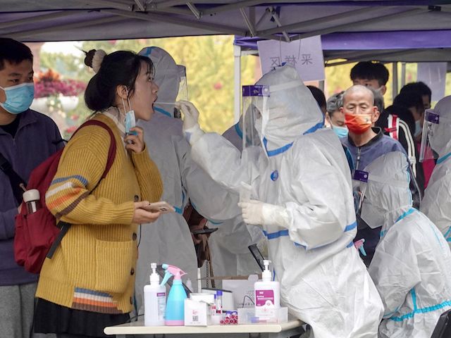A resident undergoes a nucleic acid test for the coronavirus in Xian in China's northern Shaanxi province on October 20, 2021. (STR/AFP via Getty Images)