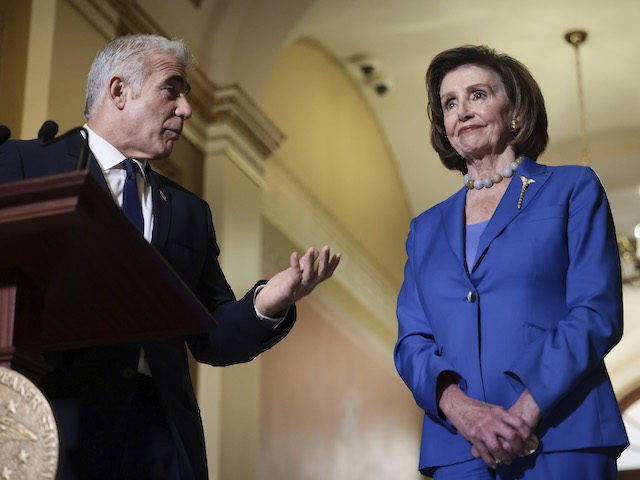 Israeli Foreign Minister Yair Lapid looks to House Speaker Nancy Pelosi (D-CA) as he gives