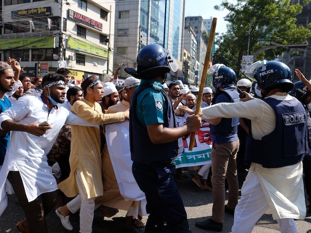 Police clash with Muslim devotees during a protest over an alleged insult to Islam, outside the country’ main Baitul Mukarram Mosque in Dhaka, Bangladesh, October 15, 2021. (AP Photo/Mahmud Hossain Opu, File)
