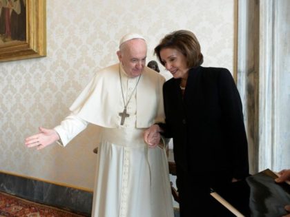 Pope Francis escorts Nancy Pelosi by the hand through the Vatican on October 9.