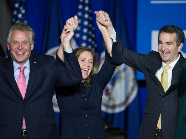 Virginia Gov.-elect Ralph Northam, right, celebrates his election victory with Virginia Gov. Terry McAuliffe and his wife Dorothy at the Northam For Governor election night party at George Mason University in Fairfax, Va., Tuesday, Nov. 7, 2017. (AP Photo/Cliff Owen)