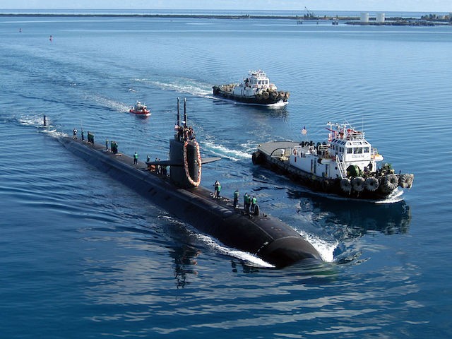 The attack submarine USS San Francisco is escorted by two harbor bug boats when it returns to Apra Harbor, Guam, after a five-month deployment on June 4, 2004. (US Navy photo / Photographer's Mate 2nd Class Mark A. Leonesio / Released)