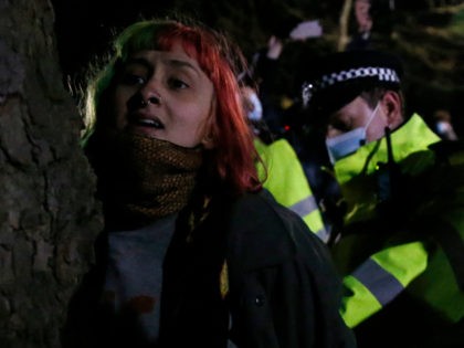 LONDON, ENGLAND - MARCH 13: A woman is arrested during a vigil for Sarah Everard on Clapham Common on March 13, 2021 in London, United Kingdom. Vigils are being held across the United Kingdom in memory of Sarah Everard. Yesterday, the Police confirmed that the remains of Ms Everard were …