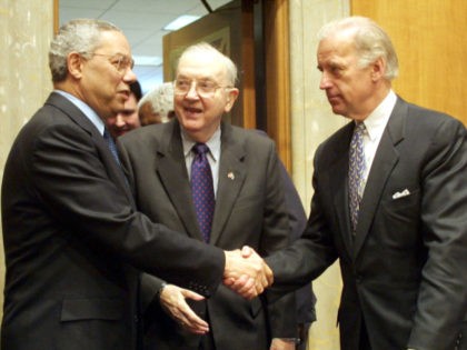 386468 01: Secretary of State Colin Powell, left, shakes hands with Sen. Joseph Biden (D-DE) as Chairman Jesse Helms (R-NC) looks on prior to a hearing on various foreign policy issues March 8, 2001 before the Senate foreign relations committee on Capitol Hill in Washington, D. C. Powell said on …