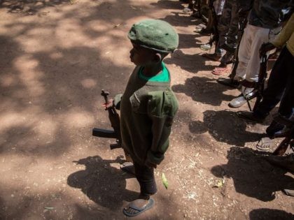 Newly released child soldiers stand with rifles during their release ceremony in Yambio, South Sudan, on February 7, 2018. (Stefanie Glinski/AFP via Getty Images)