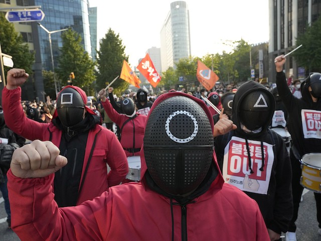Members of the South Korean Confederation of Trade Unions wearing masks and costumes inspired by the Netflix original Korean series "Squid Game" shout slogans during a rally demanding job security in Seoul, South Korea, October 20, 2021. (AP Photo/Ahn Young-joon)