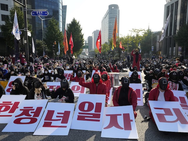 Members of the South Korean Confederation of Trade Unions wearing masks and costumes inspired by the Netflix original Korean series "Squid Game" attend in a rally demanding job security in Seoul, South Korea, October 20, 2021. (AP Photo/Ahn Young-joon)