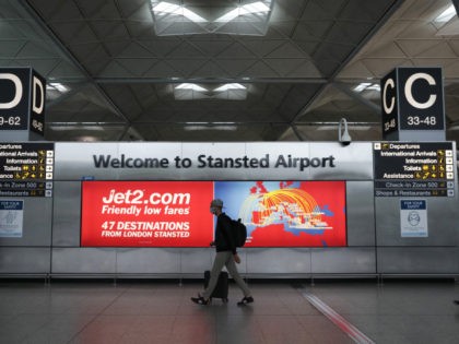 STANSTED, UNITED KINGDOM - JUNE 30: A passenger walks through departures at Stansted Airport on June 30, 2020 in Stansted, United Kingdom. Passengers travelling between the UK and some countries will no longer have to quarantine, under a new scheme to be announced by the government. The list of countries …