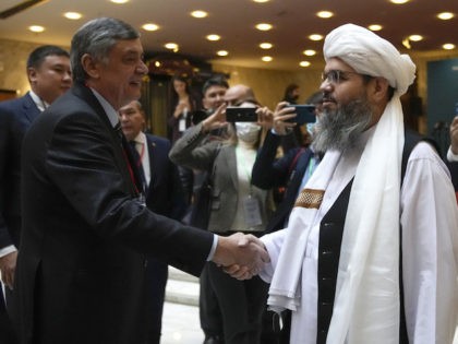 Russian presidential envoy to Afghanistan Zamir Kabulov, left, shake hands with member of political delegation from the Afghan Taliban's movement Mawlawi Shahabuddin Dilawar, right, before the opening of talks involving Afghan representatives in Moscow, Russia, October 20, 2021. (AP Photo/Alexander Zemlianichenko, Pool)
