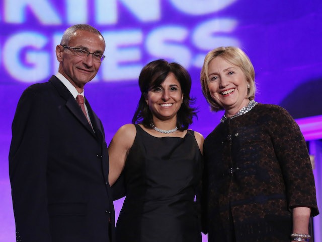 (L-R) Center for American Progress co-founder John Podesta, center President Neera Tanden and former Secretary of State Hillary Clinton pose for photographs during a gala celebrating the 10th anniversary of the center wit co-founder John Podesta (L) at the Mellon Auditorium October 24, 2013 in Washington, DC. (Chip Somodevilla/Getty Images)