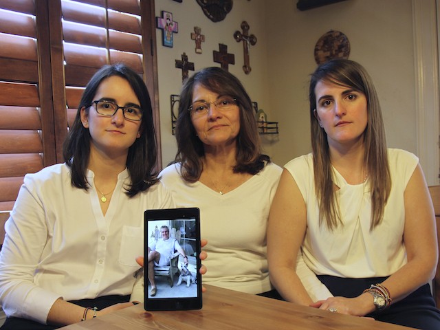 February 15, 2019, Dennysse Vadell sits between her daughters Veronica, right, and Cristina holding a digital photograph of father and husband Tomeu who is currently jailed in Venezuela, in Katy, Texas. (AP Photo/John L Mone, File)