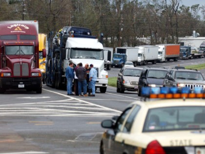 MILTON, FL - SEPTEMBER 16: Truckers wait in line for US-90 to open on September 16, 2004 in Milton, Florida. High winds and storm surge from Hurricane Ivan damaged the bridge that crosses the Escambia River north of Pensacola, Florida. (Photo by Stephen Morton/Getty Images)