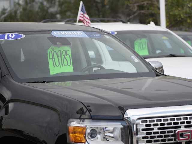 The price for a used 2019 GMC pickup truck is displayed in the windshield of the vehicle as it sits on the nearly-empty empty storage lot outside a Chevrolet dealership on August 29, 2021, in Englewood, Colorado. (AP Photo/David Zalubowski)