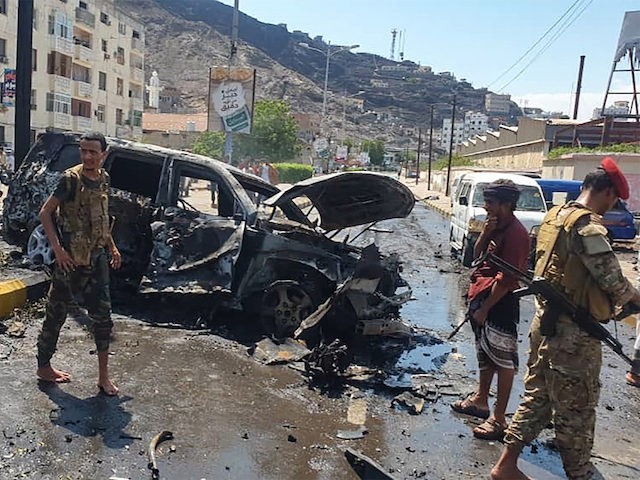 Yemeni security forces gather at the scene of a car-bomb explosion in the heart of Yemen's southern port city of Aden, on October 10, 2021. (Saleh Al-Obeidi/AFP via Getty Images)