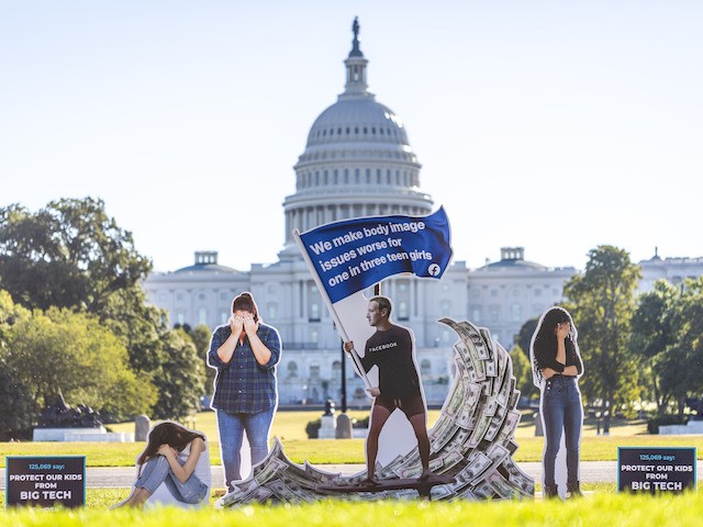 SumOfUs erected a 7ft visual protest outside the US Capitol depicting Facebook CEO Mark Zuckerberg surfing on a wave of cash, while young women surround him appearing to be suffering, September 30, 2021, in Washington. (Eric Kayne/AP Images for SumofUS)