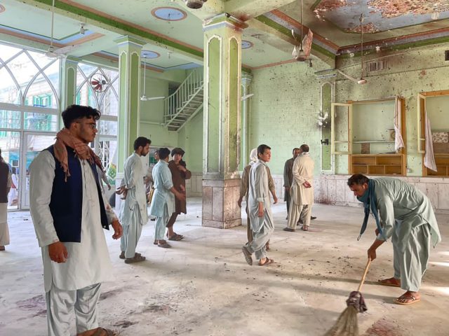 TOPSHOT - Afghan men inspect the damages inside a Shiite mosque in Kandahar on October 15, 2021, after a suicide bomb attack during Friday prayers that killed at least 33 people and injured 74 others, Taliban officials said. (Photo by JAVED TANVEER / AFP) (Photo by JAVED TANVEER/AFP via Getty …