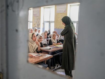 TOPSHOT - Afghan girls attend a class in a school in Kandahar on September 26, 2021. (Photo by BULENT KILIC / AFP) (Photo by BULENT KILIC/AFP via Getty Images)