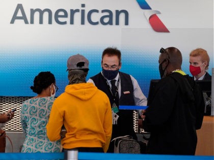 American Airlines employees work at ticket counters in Terminal 3 at O'Hare International