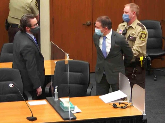 In this image from video, former Minneapolis police Officer Derek Chauvin, center, is take