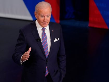 President Joe Biden participates in a CNN town hall at the Baltimore Center Stage Pearlstone Theater, Thursday, Oct. 21, 2021, in Baltimore, with moderator Anderson Cooper. (AP Photo/Evan Vucci)