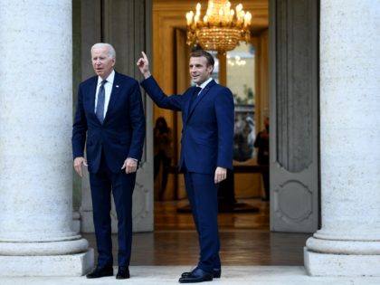 French President Emmanuel Macron (R) welcomes US President Joe Biden (L) before their meeting at the French Embassy to the Vatican in Rome on October 29, 2021. (Photo by Brendan Smialowski / AFP) (Photo by BRENDAN SMIALOWSKI/AFP via Getty Images)