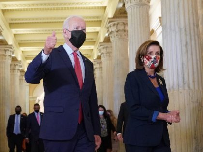 US President Joe Biden gives a thumbs up as he walks with Speaker of the House Nancy Pelosi upon departing the US Capitol after a caucus meeting in Washington, DC, on October 1, 2021. - President Biden headed to Congress to energize Democrats negotiating for a second day on getting …