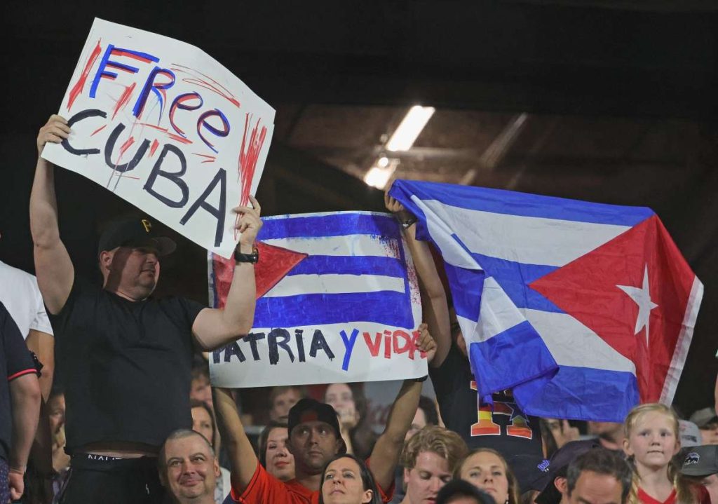 CHICAGO, ILLINOIS - JULY 16: Fans hold signs and a Cuban flag as the Chicago White Sox take on the Houston Astros at Guaranteed Rate Field on July 16, 2021 in Chicago, Illinois. (Photo by Jonathan Daniel/Getty Images)