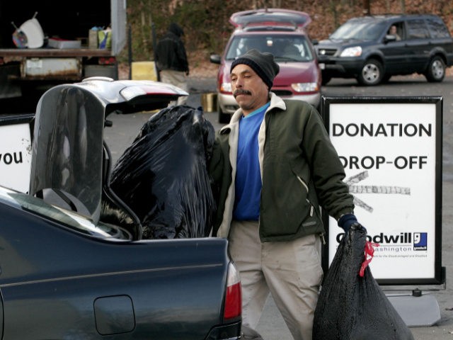 ARLINGTON, VA - DECEMBER 30: Goodwill Industries of Greater Washington employee Edward Hawkins unloads bags of donated goods at a drop-off point December 30, 2005 in Arlington, Virginia. Charity organizations like Goodwill see a surge in donations at the end of the calendar year before the 2005 tax deduction deadline. …