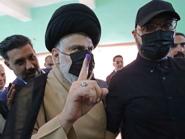 Iraq's populist cleric Moqtada Sadr shows indelible ink on his finger after voting in the central Iraqi shrine city of Najaf on October 10, 2021 in an early parliamentary election billed as a concession to anti-government protests but expected to be boycotted by many voters who distrust official promises of reform. (Ali Najafi/AFP via Getty Images)