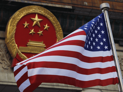 In this Nov. 9, 2017, file photo, an American flag is flown next to the Chinese national e