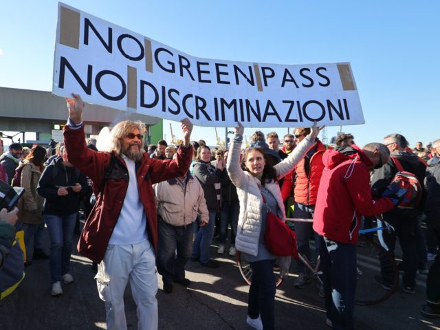 his photo obtained from Italian news agency Ansa shows dockers and port workers gathering for a protest in the port of Trieste, Friuli Venezia Giulia, on October 15, 2021 as new coronavirus restrictions for workers come into effect. - Italy braced for nationwide protests, blockades and potential disruption on October …