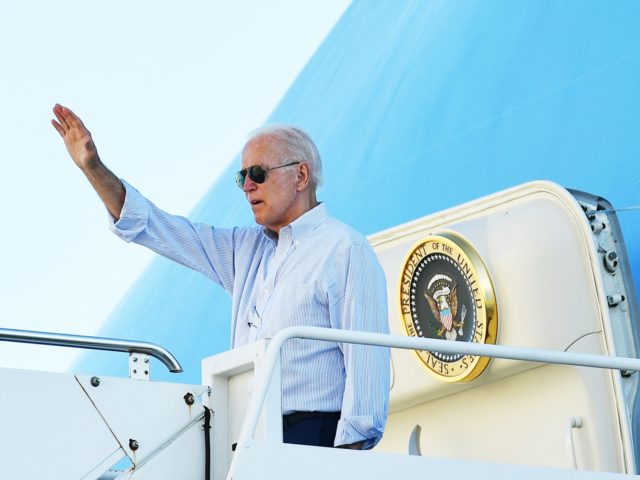 US President Joe Biden waves as he boards Air Force One before departing John F. Kennedy I