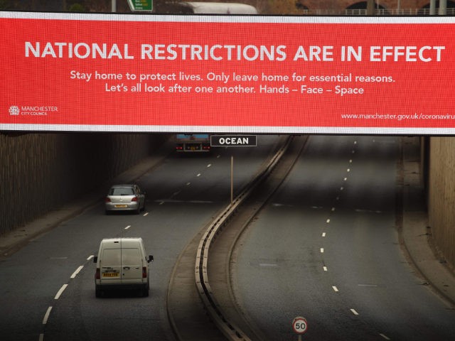 A billboard displays a Manchester City Council message about the about the national lockdown restrictions to combat the novel coronavirus pandemic in Manchester, northwest England, on November 26, 2020. - The UK announced details of a new tiered system of coronavirus restrictions on public life that is set to replace …