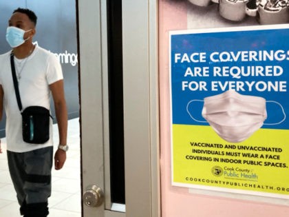 An information sign is displayed at a department store in Rosemont, Ill., Thursday, Aug. 26, 2021. Gov. J.B. Pritzker of Illinois announced on Thursday a new, stricter set of coronavirus restrictions, ordering a statewide indoor mask mandate and requiring that all educators be vaccinated or face regular testing. (AP Photo/Nam …