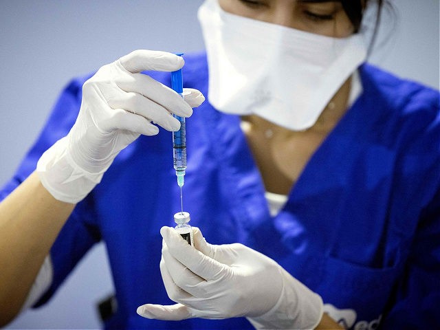 A Moroccan health worker prepares of the Pfizer-BioNTech at a Covid-19 vaccination centre, in the city of Sale, on October 5, 2021. (Photo by FADEL SENNA / AFP) (Photo by FADEL SENNA/AFP via Getty Images)