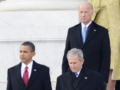 President Barack Obama (L) walks with Former President George W. Bush (R) as they are followed by Vice President Joe Biden (C) and first lady Michelle Obama (in yellow) and former first lady Laura Bush (R) on the East Front of the US Capitol Building after Barack Obama was sworn …
