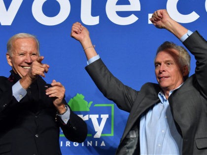 US President Joe Biden (L) and Virginia Democratic gubernatorial candidate Terry McAuliffe gesture during a campaign event at Virginia Highlands Park in Arlington, Virginia on October 26, 2021. (Photo by Nicholas Kamm / AFP) (Photo by NICHOLAS KAMM/AFP via Getty Images)