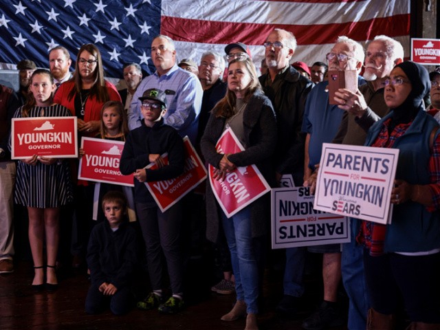 DANVILLE, VIRGINIA - OCTOBER 26: Audience members listen as Virginia Republican gubernatorial candidate Glenn Youngkin gives remarks at a campaign rally at the Danville Community Market on October 26, 2021 in Danville, Virginia. Youngkin is contesting Democratic candidate and former Gov. Terry McAuliffe in the state election that is a week away on November 2. (Photo by Anna Moneymaker/Getty Images)