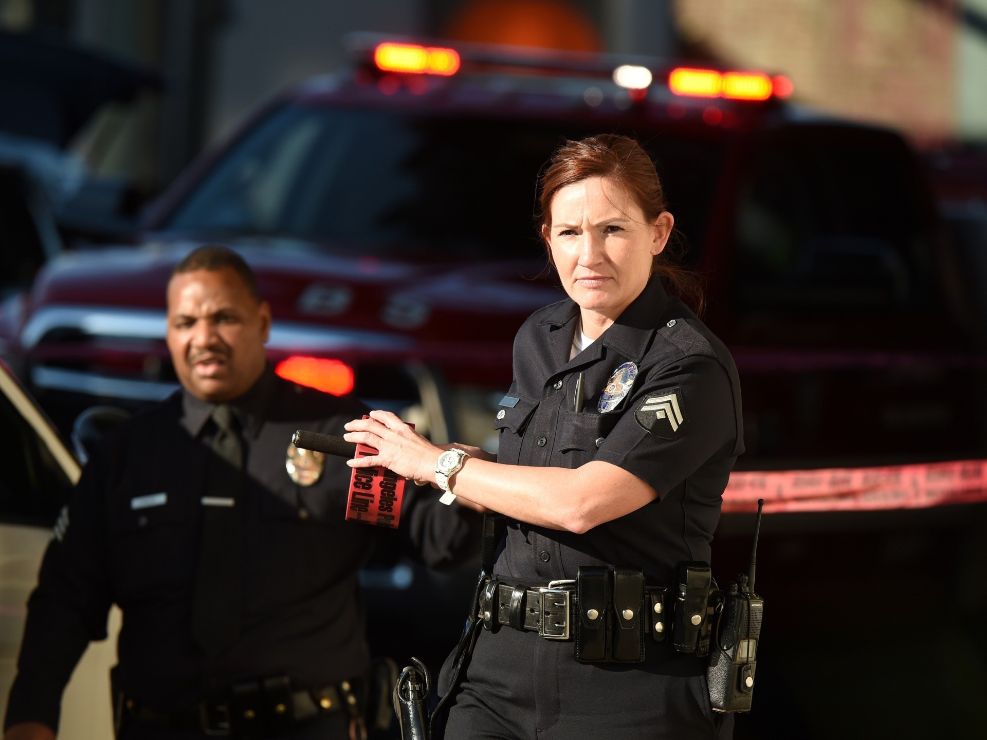 A female police officer uses police tape to cordon off an area outside a Jack in the Box restaurant in Hollywood, California, January 31, 2017, after police shot and killed a knife-wielding suspect inside the restaurant following a series of stabbing in the vicinity. Authorities said a person described only as a male was pronounced dead at the scene, while two of the male stabbing victims have critical injuries and a third was in fair condition. / AFP / Robyn Beck (Photo credit should read ROBYN BECK/AFP via Getty Images)