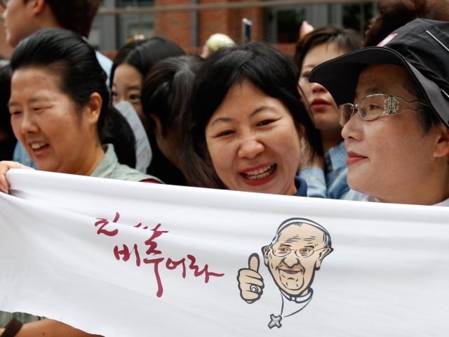 SEOUL, SOUTH KOREA - AUGUST 18: Catholic worshippers gather ahead of a mass by Pope Francis at Myeong-dong Cathedral on August 18, 2014 in Seoul, South Korea. Pope Francis is visiting South Korea from August 14 to August 18. This trip is the third trip abroad for the pope following …