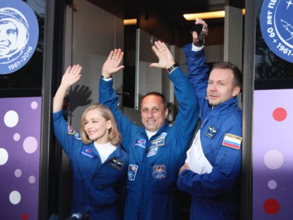 In this handout photo released by Roscosmos, actress Yulia Peresild, left, film director Klim Shipenko, right, and cosmonaut Anton Shkaplerov wave from a bus prior to the launch at the Baikonur Cosmodrome, Kazakhstan, Tuesday, Oct. 5, 2021. Actress Yulia Peresild and film director Klim Shipenko blasted off Tuesday for the …