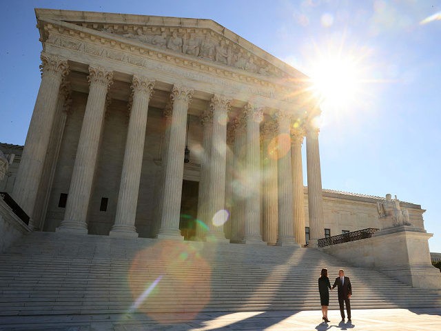 WASHINGTON, DC - OCTOBER 01: U.S. Supreme Court Associate Justice Amy Coney Barrett (L) sh