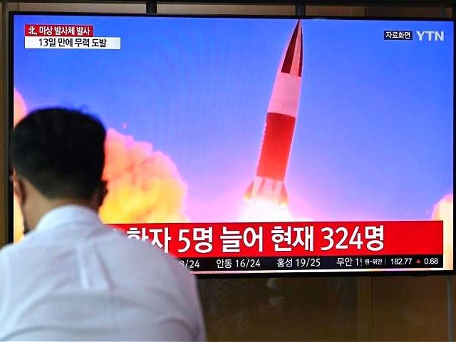 People watch a TV news showing archival footage of a North Korean missile test, at a train station in Seoul on September 28, 2021, after North Korea fired a 