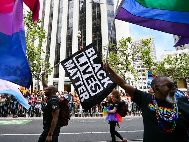 SAN FRANCISCO, CA - JUNE 25: Men wave rainbow and 'black lives matter' flags while marching in the annual LGBTQI Pride Parade on Sunday, June 25, 2017 in San Francisco, California. The LGBT community descended on Market Street for the 47th annual Pride Parade. (Photo by Elijah Nouvelage/Getty Images)