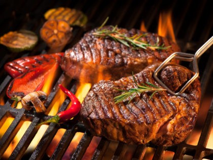 Beef steaks on the grill - stock photo Beef steaks on the grill with flames