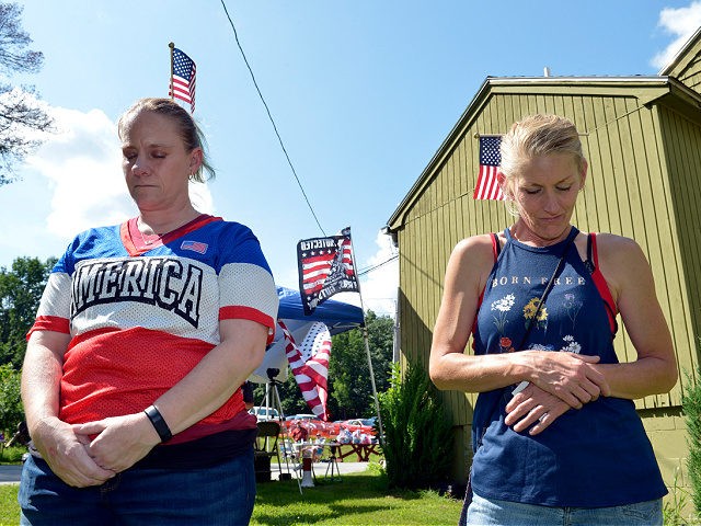 People pray at a festival held by the far right group 'Super Happy Fun America' in Auburn, Massachusetts on July 24, 2021. - Leaders of Super Happy Fun America, a far right group that took part in Capital riots on January 6th, 2021, held a summer festival called the The …