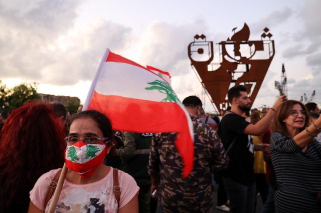 Dozens of protesters marched in the Lebanese capital Beirut on October 17, 2021 to mark th