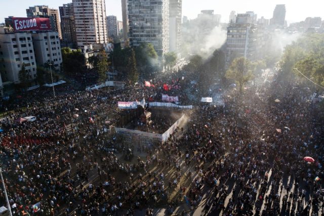 Demonstrators mark the second anniversary of months of unrest against social inequality, a