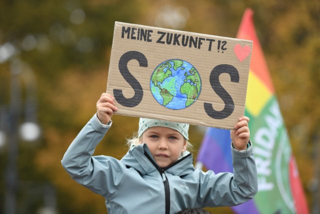 'My future? SOS' reads a placard held up by a very young activist at the climate rally in
