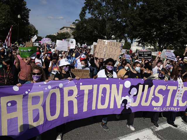 WASHINGTON, DC - OCTOBER 02: Women rights activists participate in the annual Women’s March October 2, 2021 in Washington, DC. The annual march returns to Washington for the fifth time with a focus on fighting for abortion rights. (Photo by Alex Wong/Getty Images)